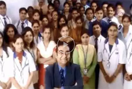Large group of doctors and a man in a suit.